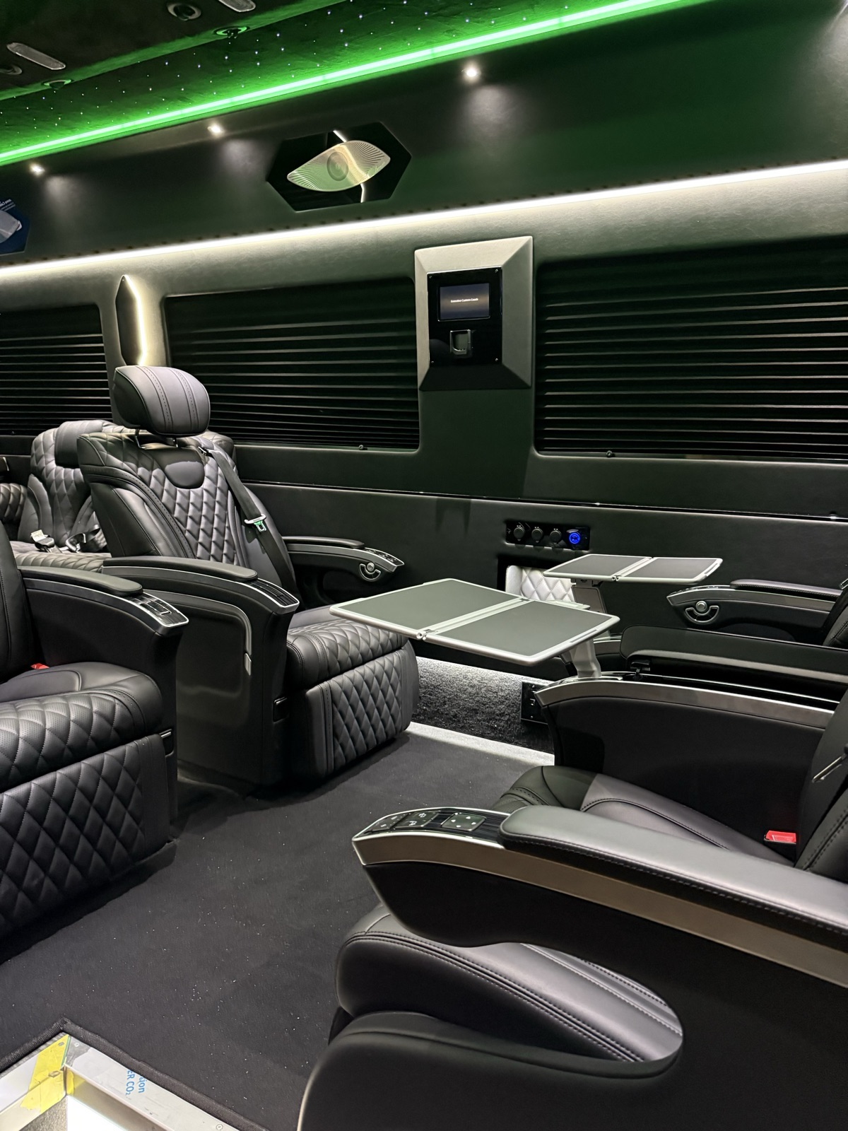 VIP Sprinter seating with tables and green ambient lighting